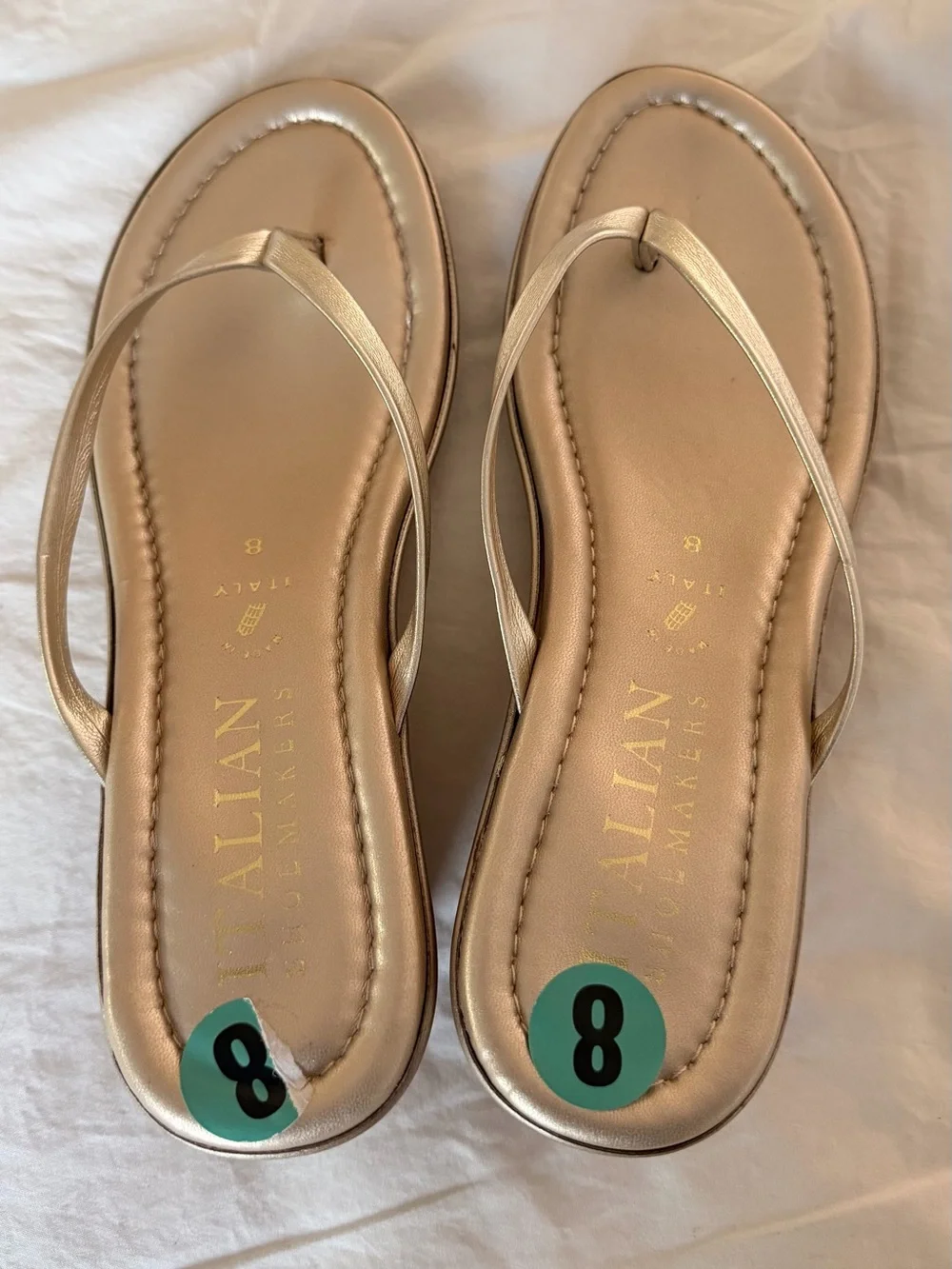 Italian Shoemakers thong wedge sandals feature a metallic gold finish